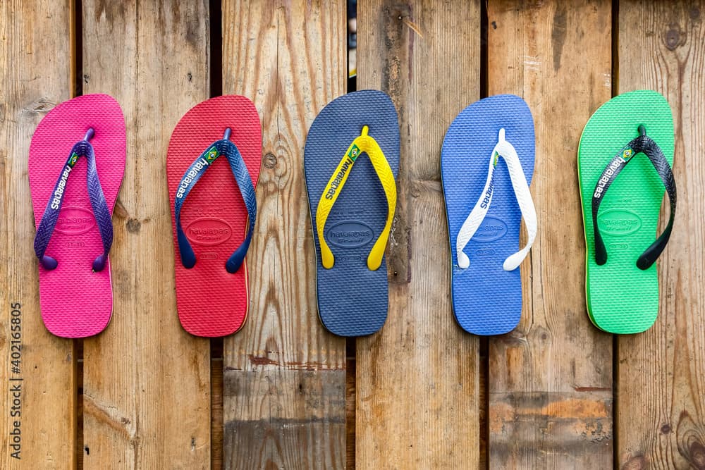 5 colourful sandals on a wooden background