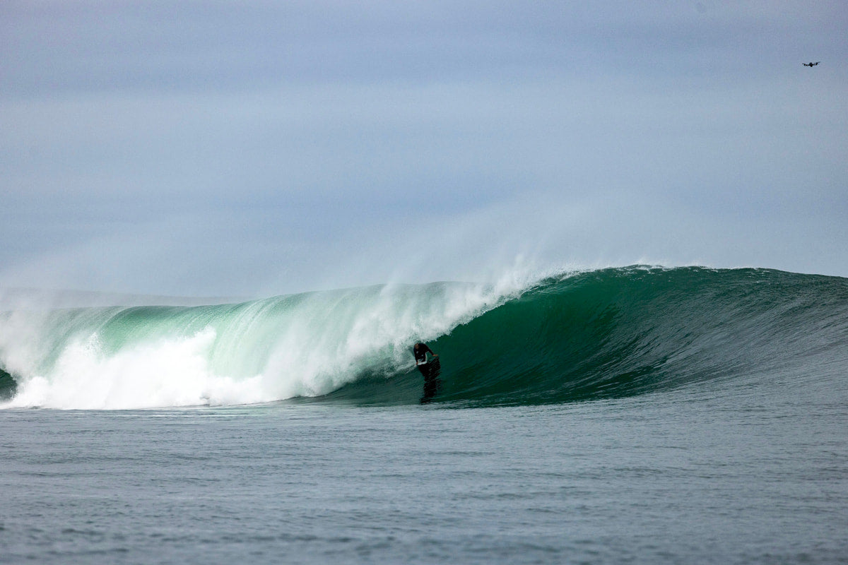 A surfer in the barrel of a wave 