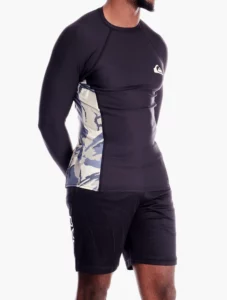 A man wearing a rash vest for sun protection